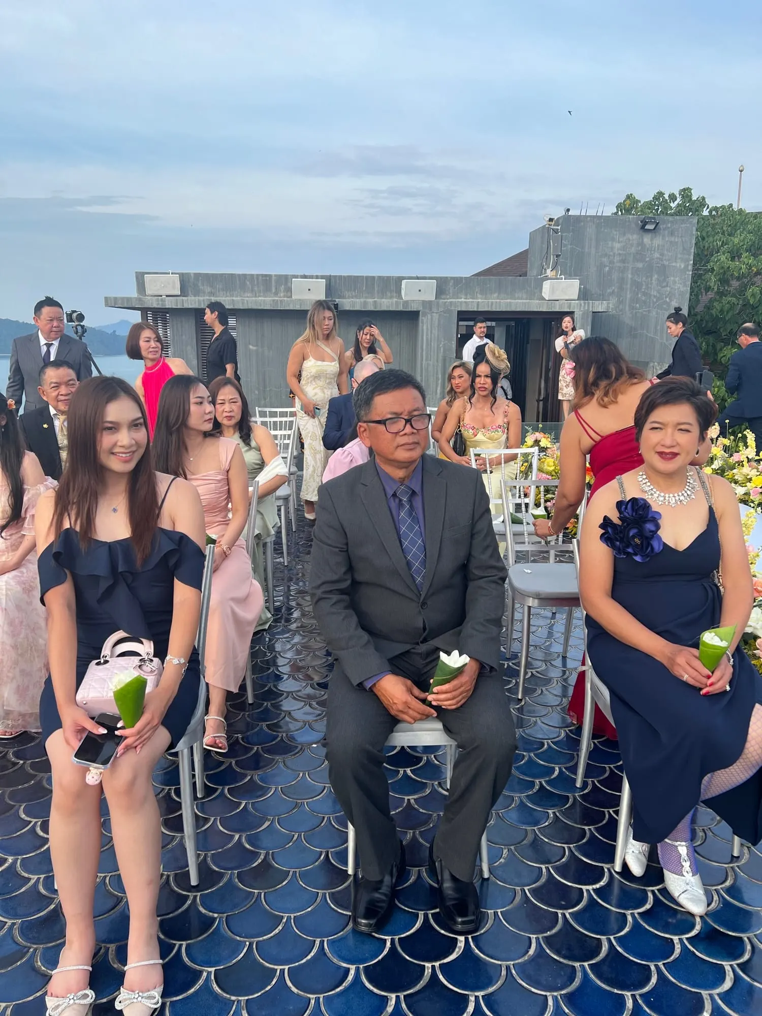 Wefam family and guests gathered at a seaside rooftop event