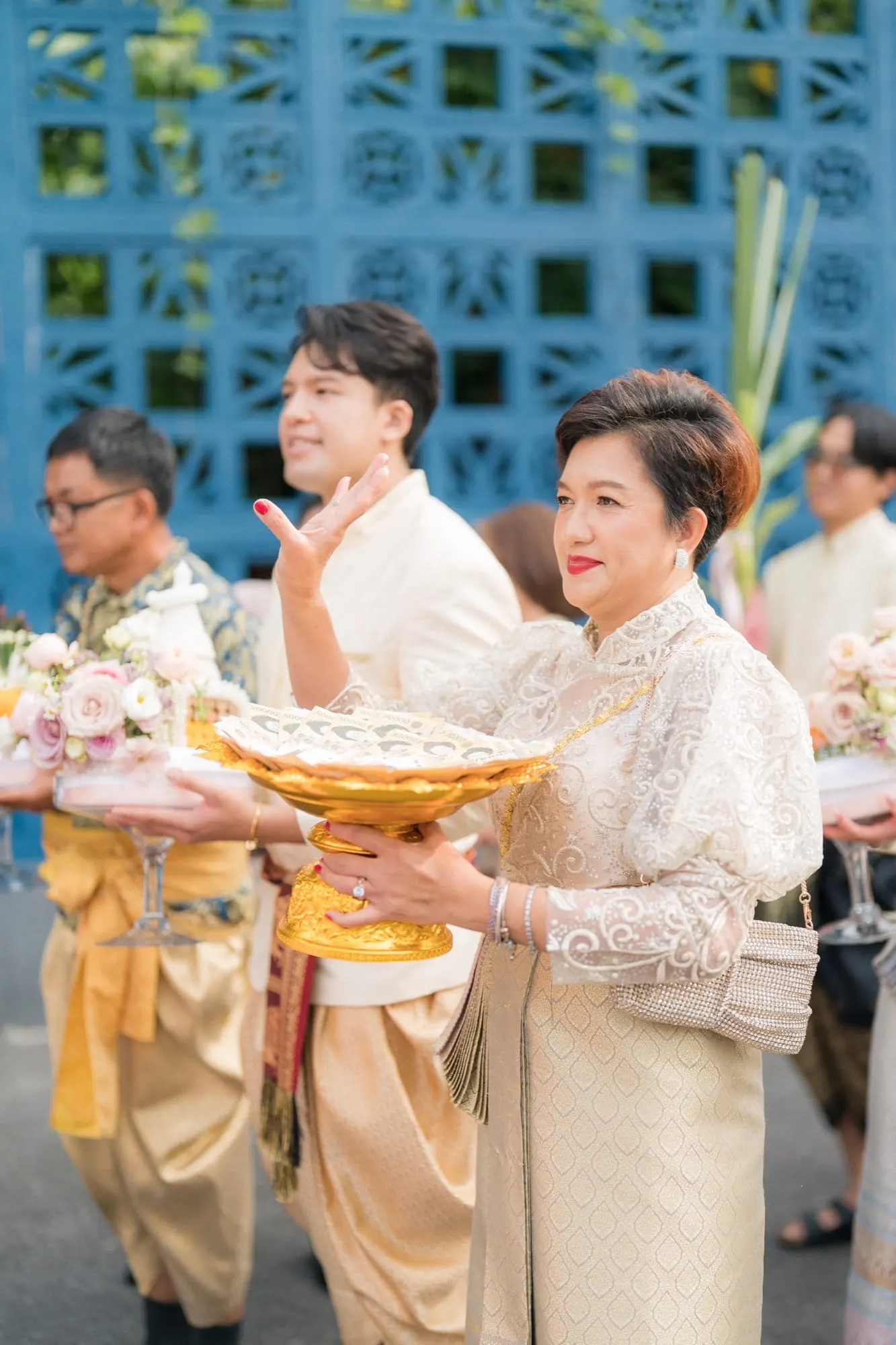 Wefam family members in traditional Thai dress at a ceremony